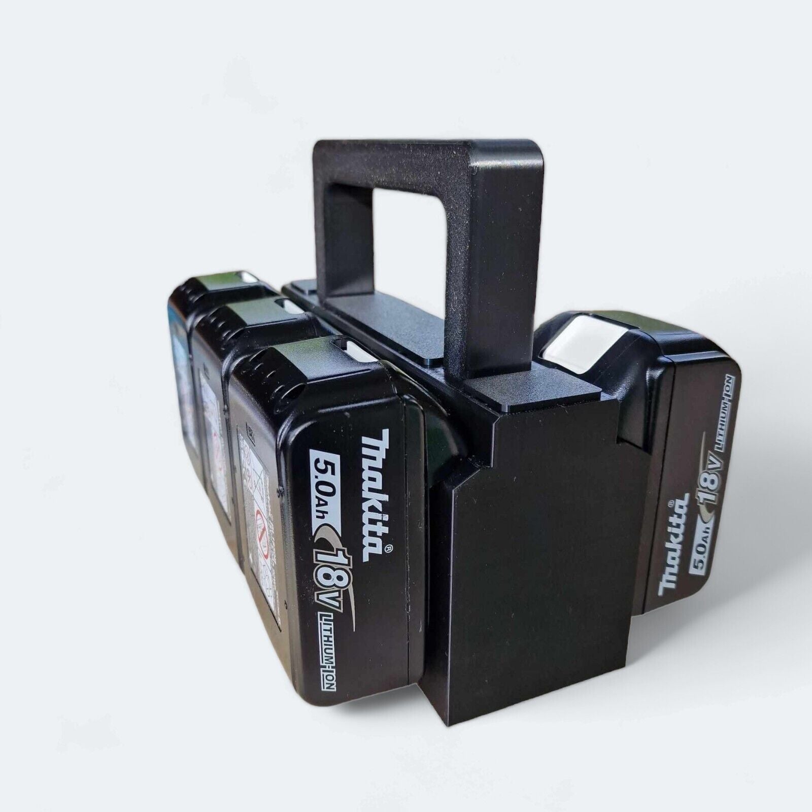 A stylish black six-slot battery basket from Battery is holding four 18V 5.0Ah Makita lithium-ion batteries. This 3D printed caddy features a handle for easy carrying, with three storage compartments allowing the batteries to be neatly aligned side by side for convenient access.